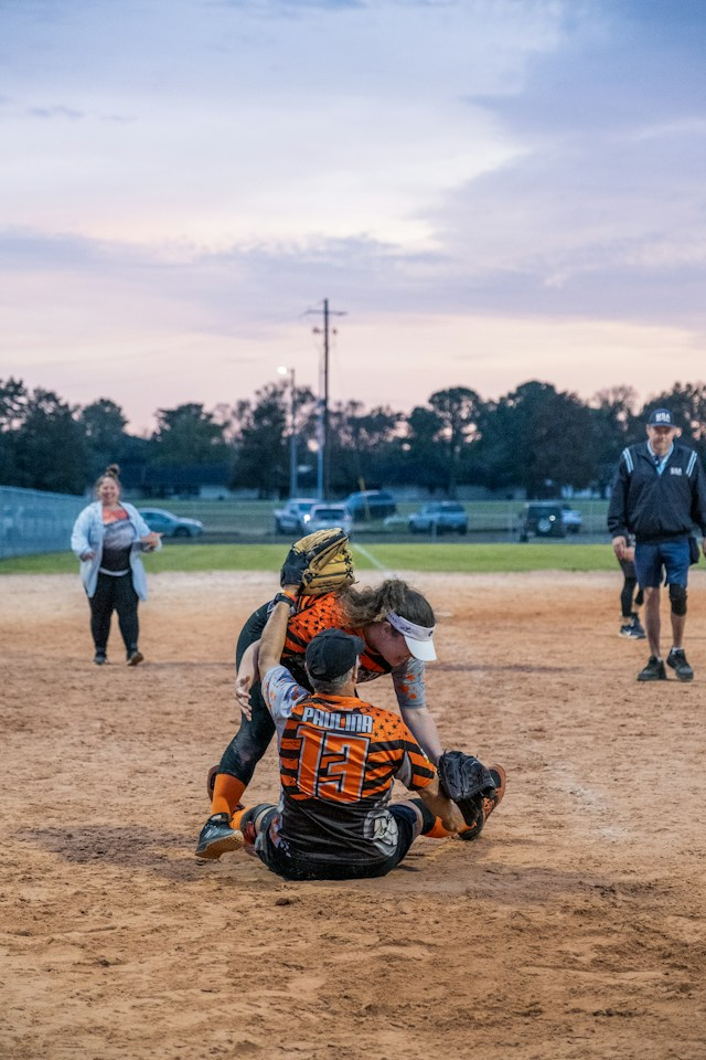 Team Support is the way to play the game two-softball-players-giving-team-support-to-one-another